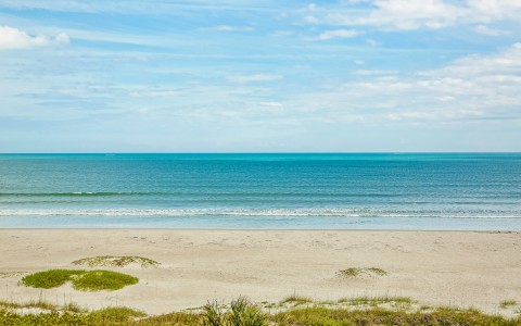 Ocean with yellow sand and blue waters 